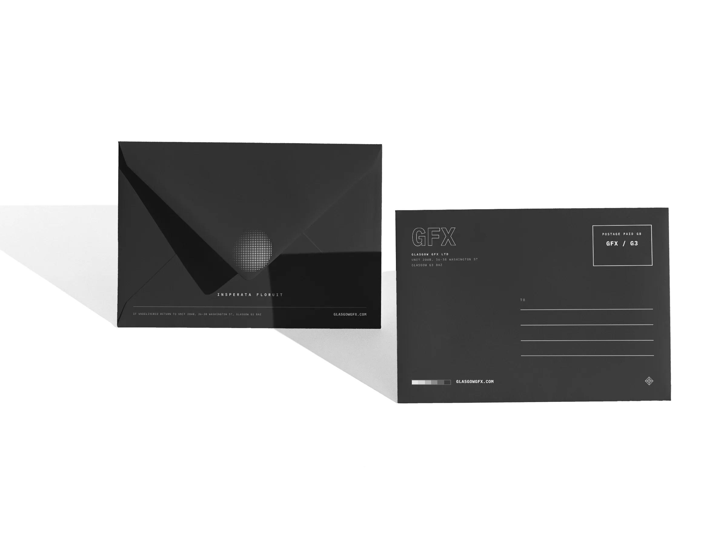 Printed C6 envelopes, flap side and address side, standing on a white studio surface