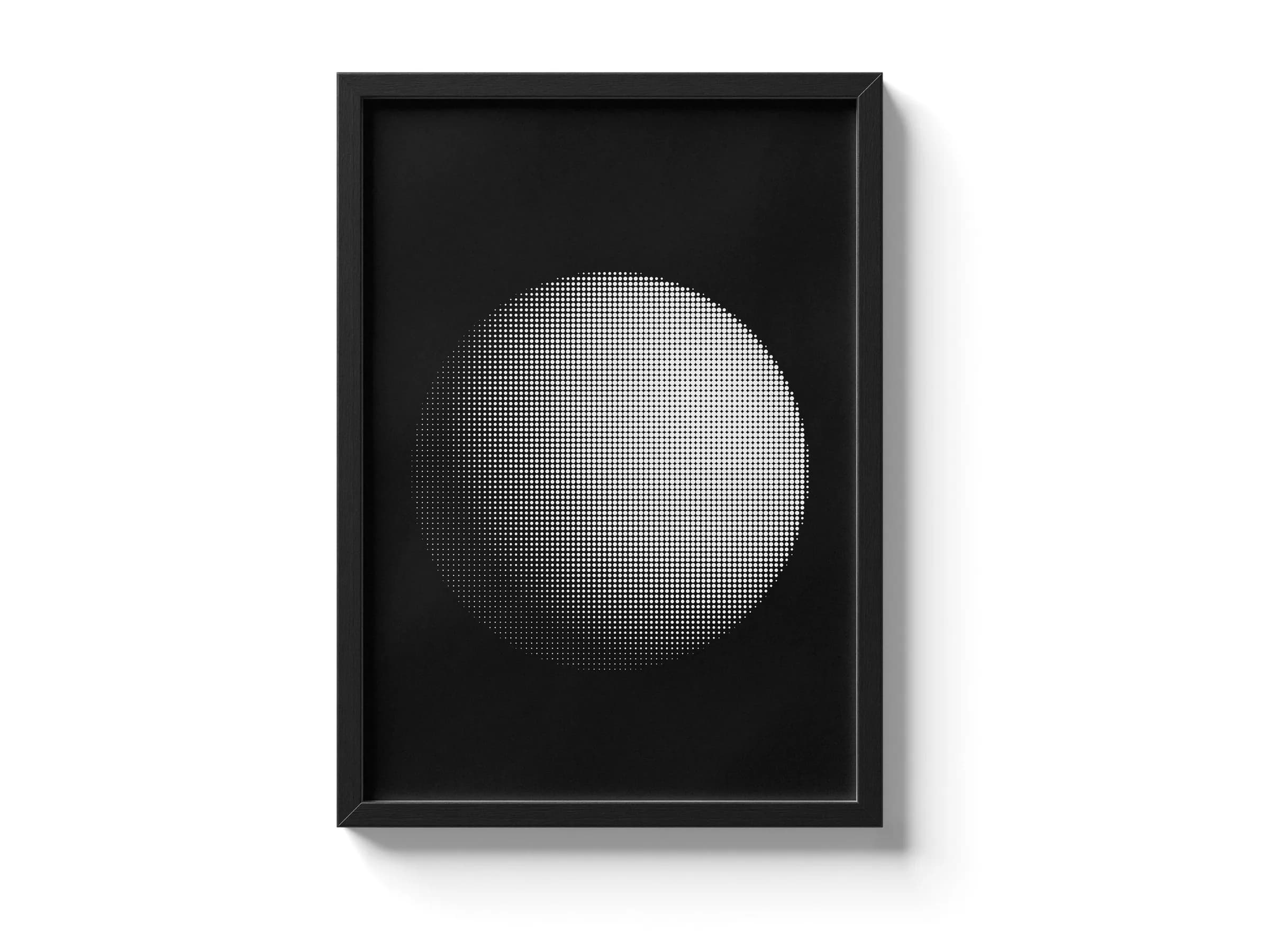 Framed print of a halftone sphere artwork against a white studio background