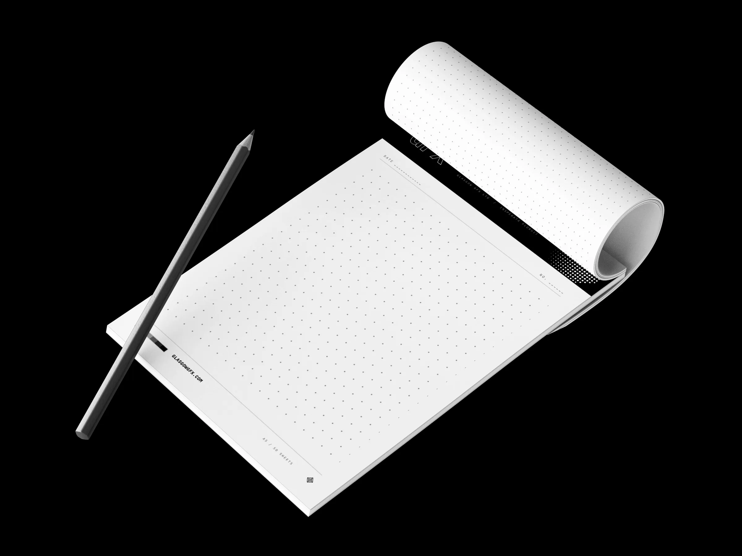 A5 dot-grid notepad with a printed header band, top sheet rolled back, beside a pencil on a white studio surface