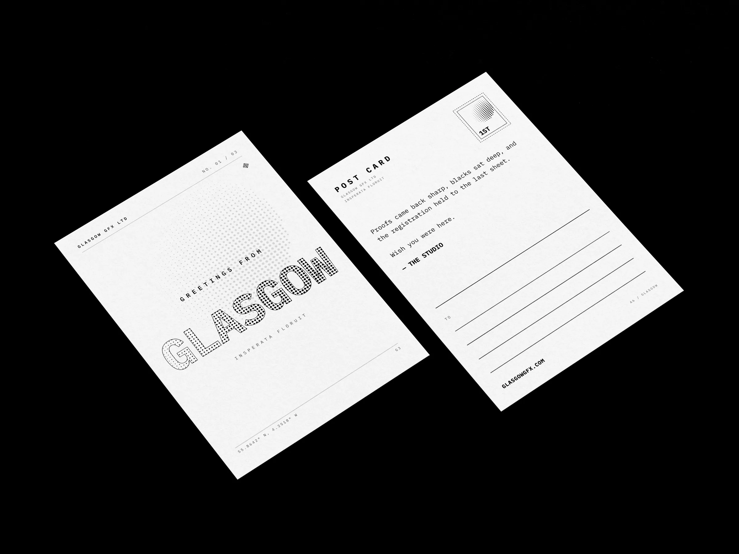 A6 postcards, halftone Glasgow front and address back, on a white studio surface