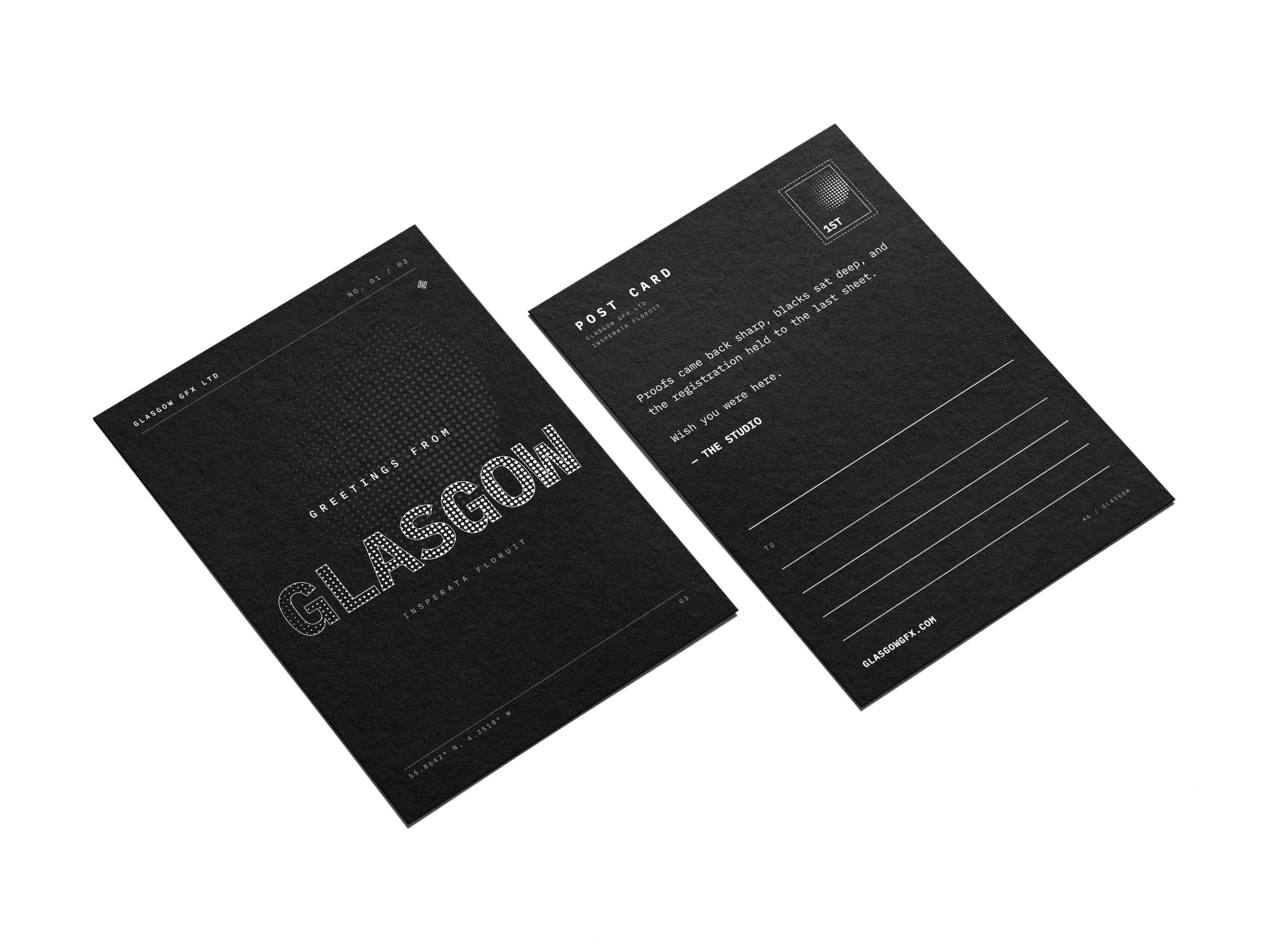 A6 postcards, halftone Glasgow front and address back, on a white studio surface