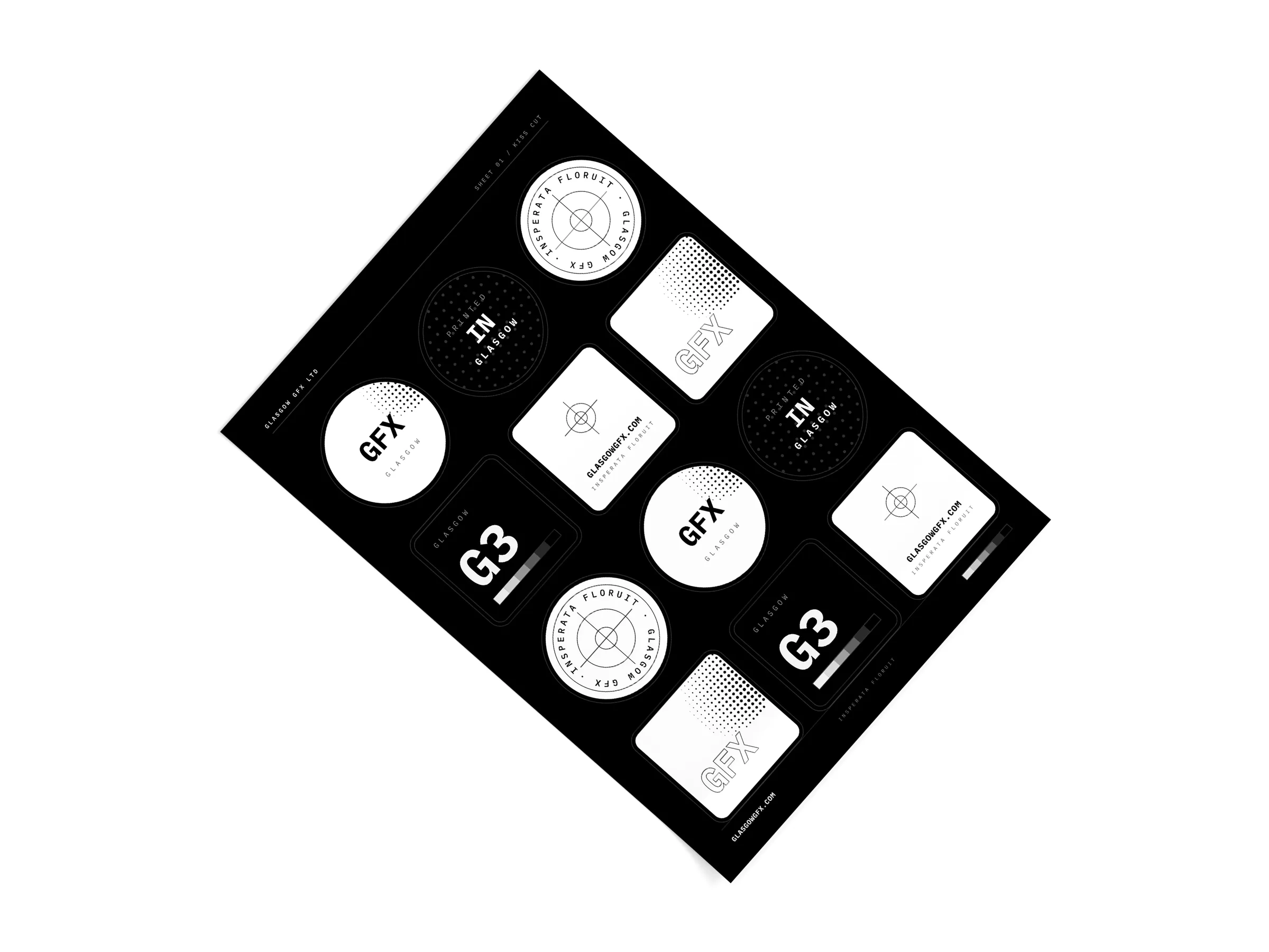 A4 kiss-cut sticker sheet with round and square GFX stickers on a white studio surface